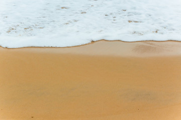 Soft Blue ocean wave on sandy beach. tropical white sand With the sea at the corner.