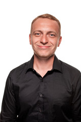 Obraz premium Handsome young blond man in a black shirt, isolated on a white background