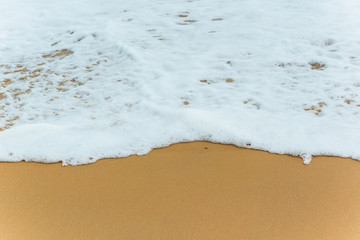 Soft Blue ocean wave on sandy beach. tropical white sand With the sea at the corner.