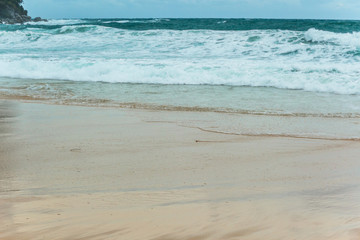 Soft Blue ocean wave on sandy beach. tropical white sand With the sea at the corner.