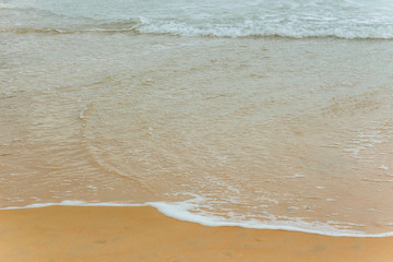 Soft Blue ocean wave on sandy beach. tropical white sand With the sea at the corner.