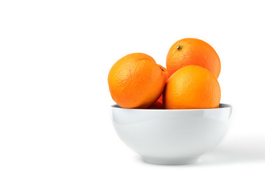 Fresh juicy oranges on white plate on white background
