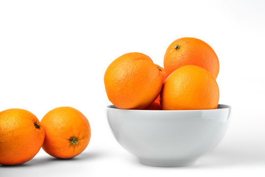 Fresh juicy oranges on white plate on white background