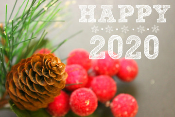 2020, Christmas decoration, fir cone and branch, red berries, happy new year 2020 text. Copy space. New year greetings, postcards.