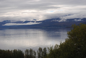 Fototapeta premium Fjord with clouds hiding the mountains