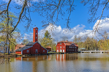 Old factory wooden buildings painted in traditional red ochre at Stromfors Iron Works, Finland.