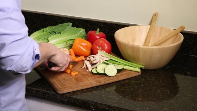 Medium shot of man cutting carrots