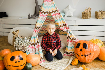 Halloween boy with pumpkin.