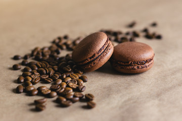 Chocolate and coffee French macarons with coffee beans. Close up.