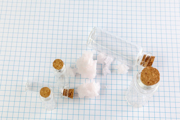 Medical Glass container with cork stopper are on the notebook.