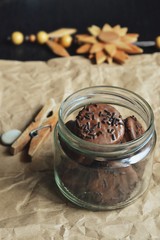 Obraz na płótnie Canvas Cookies in milk chocolate in a glass jar.