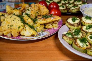 homemade cauliflower in batter and zucchini with tartar sauce and tomatoes