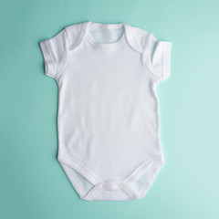 Flat Put a white bodysuit for a child on a neutral background. Layout for design and placement of logos, advertising