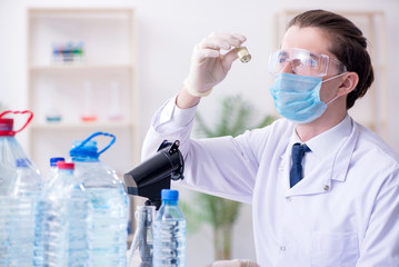 Young male chemist experimenting in lab