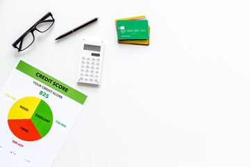 credit score with credit cards and calculator, glasses on banker work place white background top...
