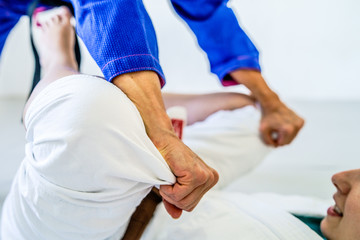 Grips from the guard in brazilian jiu jitsu bjj training sparring two female women athletes...