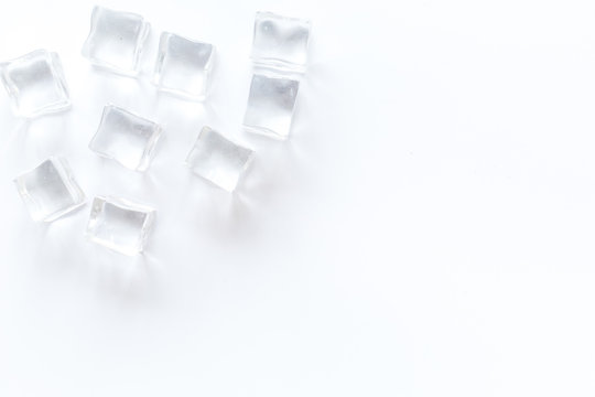 Pile of ice cubes on white bar desk background top view mockup