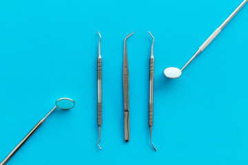 stomatologist instruments on blue doctor's office desk background top view