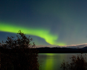 Aurora borealis reflected on Lake Laberge Yukon