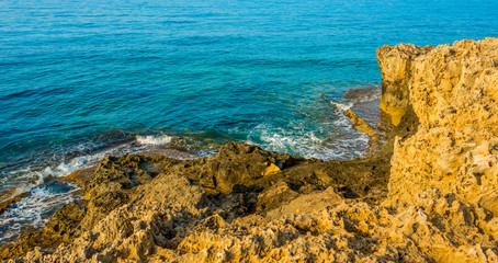 beautiful view of the sea and rocks off the coast of Cyprus, Ayia Napa, bathed in the morning sun