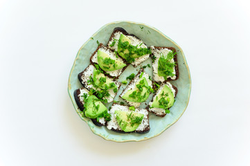 Tasty avocado toast in a plate on white background