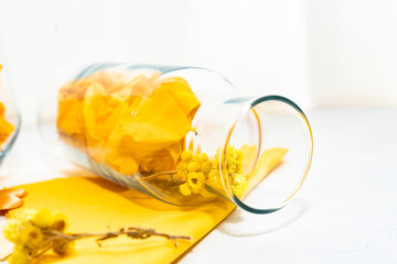 glass bottle and yellow flower 