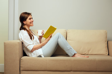 Woman resting at home with book