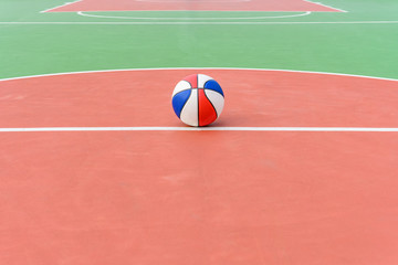 colorful basketball ball on the central part of an outdoor court