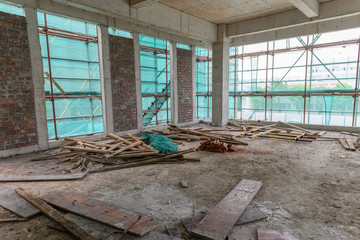 inside of an unfinshed building with protection scaffolding and netting surrounded