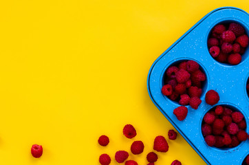 Raspberries on yellow background. Close up, top view