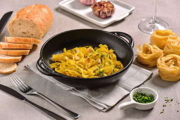 Traditional Italian pasta on black rustic pan