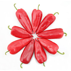 nine bright red sweet peppers on a white background