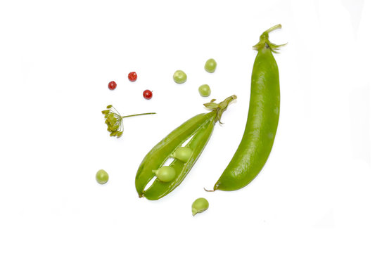 green pea pods and peas and dill selective focus white background
