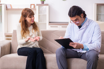 Young female patient discussing with male psychologist personal