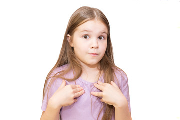 The little girl shyly points to herself. Isolated on a white background.