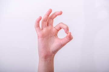 Woman hand pointing up okay gesture, woman gesturing okay, yes, accepting hand sign, isolated photo