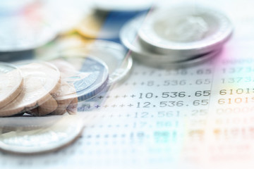 Double exposure of Thai's coins stacked over page of Bank account statement with Business activity image.Business and  Collecting money concept