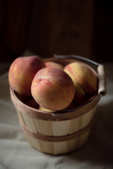 Peaches in a wooden basket - 284043050