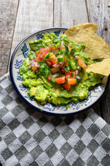Mexican guacamole sauce on wooden background