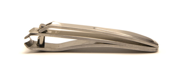 Fototapeta premium metal nail clippers lie on a white background