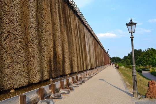 GERMANY, BAD ROTHENFELDE, 2018: Salt cooling tower in the resort town.Footpath along the salt wall for walking and breathing in the sea air.