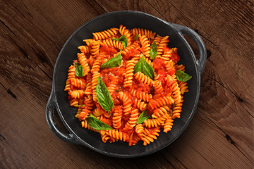 Traditional Italian pasta on black rustic pan