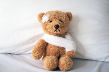 Teddy bear and bandage. Injury concept