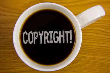 Word writing text Copyright Motivational Call. Business concept for Saying no to intellectual property piracy written Black Tea in White Cup placed wooden table. Top view.