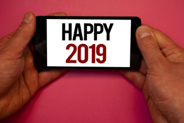 Conceptual hand writing showing Happy 2019. Business photo showcasing New Year Celebration Cheers Congrats Motivational MessageMan hold holding cell phone white screen black red letters