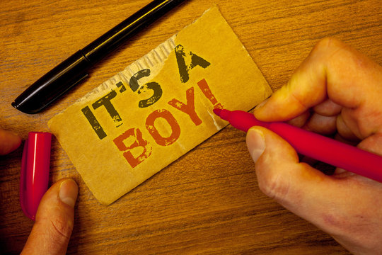 Writing note showing It S A Boy Motivational Call. Business photo showcasing Male baby is coming Gender reveal CelebrationMan creating on yellow paper Hand holding red black pens wooden table
