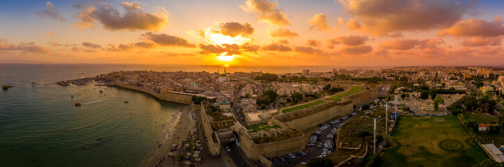 Aerial summer sunset view of Acco, Acre, Akko medieval old city with green roof Al Jazzar mosque...