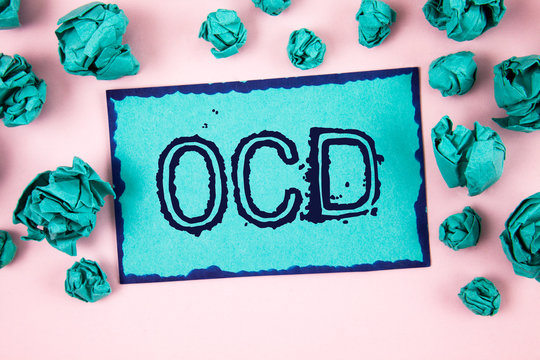 Writing note showing Ocd. Business photo showcasing Obsessive Compulsive Disorder Psychological Illness Medical Condition written Sticky Note paper plain Pink background Paper Balls.