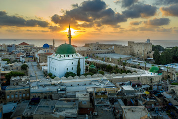 Aerial summer sunset view of Acco, Acre, Akko medieval old city with green roof Al Jazzar mosque...