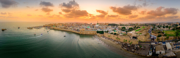 Aerial summer sunset view of Acco, Acre, Akko medieval old city with green roof Al Jazzar mosque...